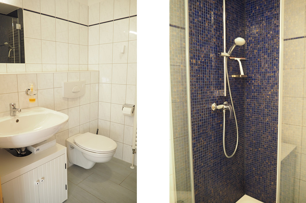 Badezimmer mit Dusche und Waschmaschine